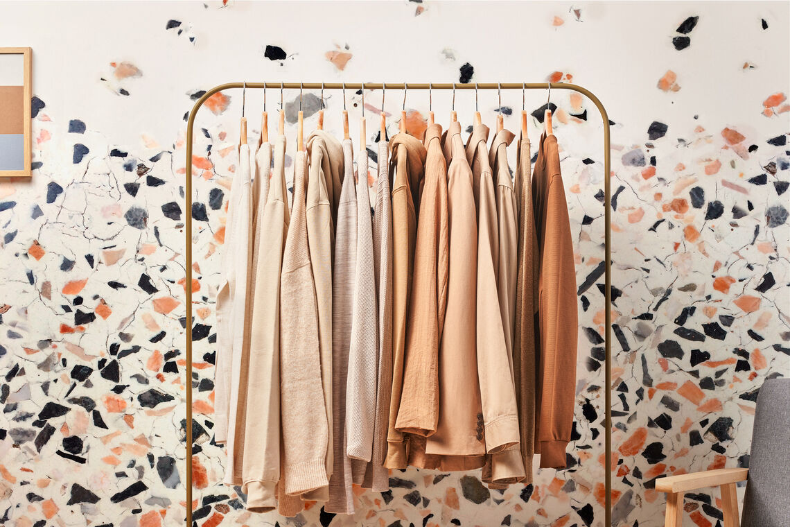 customized wallcovering behind a clothing rack in a retail store