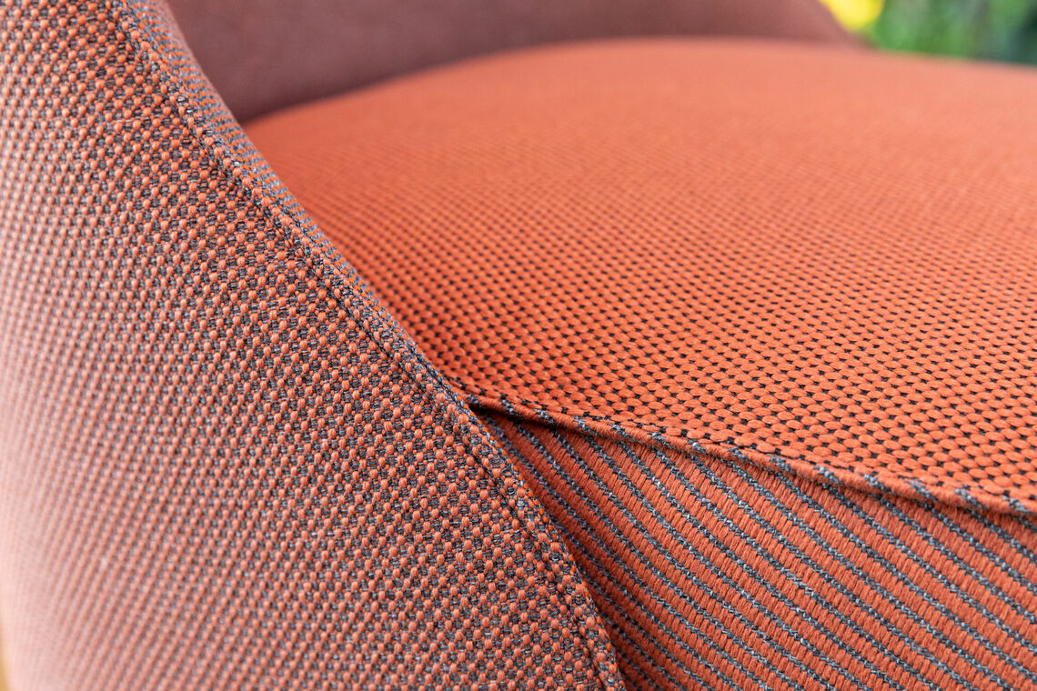 close up of multiple fabrics mixed and matched on a lounge chair