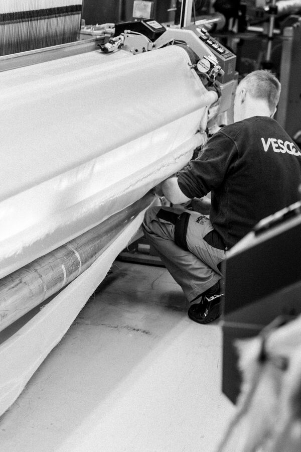 Vescom employee working on a production machine